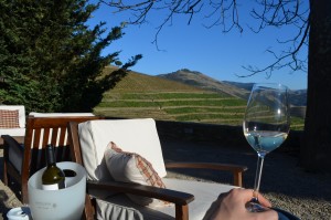 A glass of Quinta Nova's Grainha Reserva Branco on the winery terrace; Douro, Portugal.