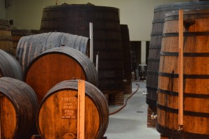 Different sizes of Portuguese oak barrels age Port wines at Porto Poças in Vila de Gaia, Portugal